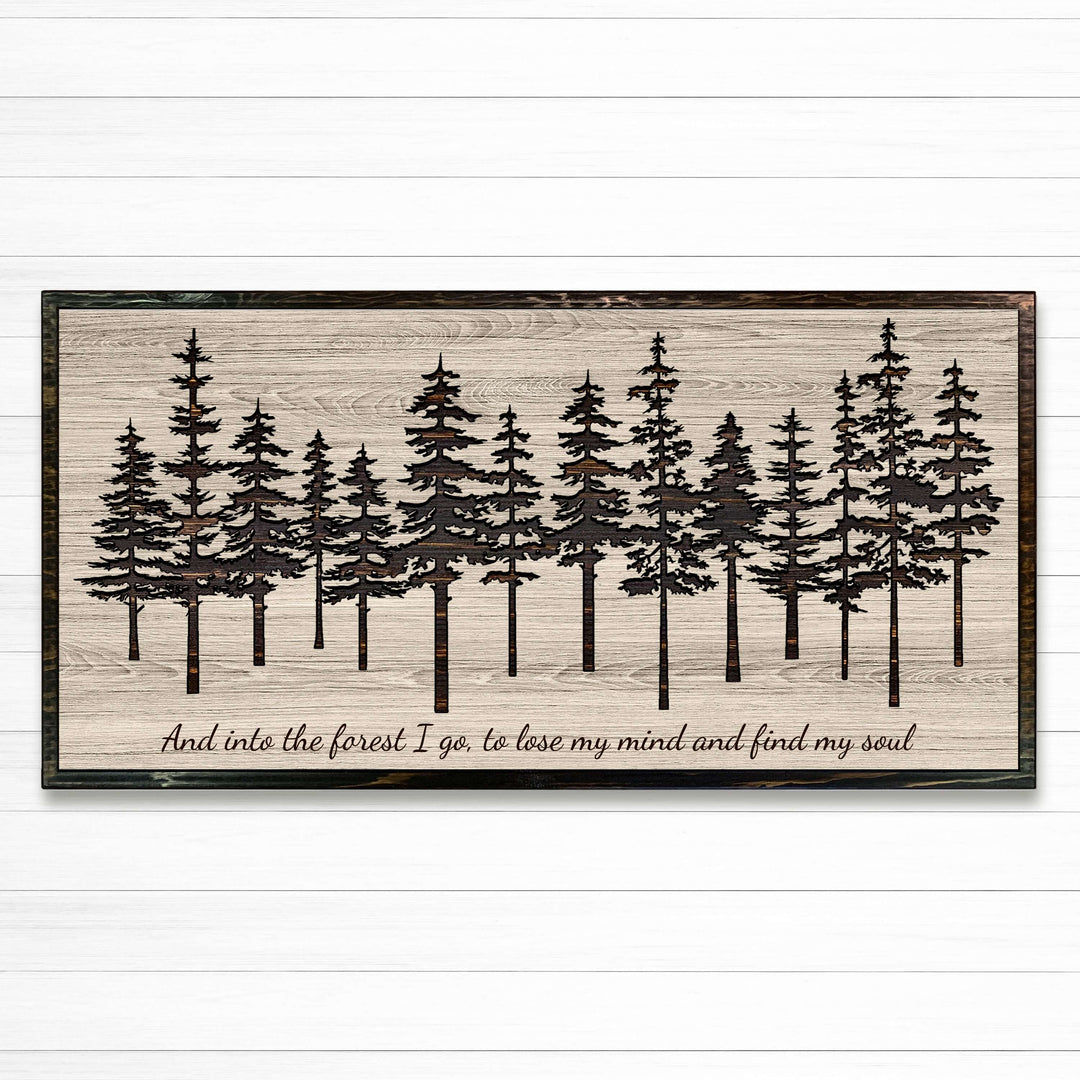 Pine tree forest wood wall art carved into solid wood. The stunning artwork features a carved pine tree scene nestled against a serene forest backdrop. That natural variations in the wood grain add a depth and character to the overall design, creating a warm and inviting atmosphere for any room.