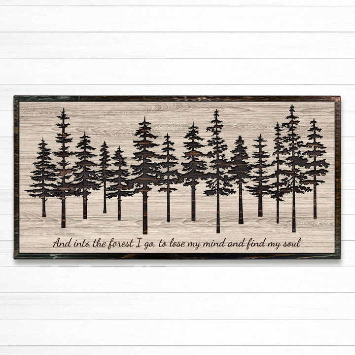 Pine tree forest wood wall art carved into solid wood. The stunning artwork features a carved pine tree scene nestled against a serene forest backdrop. That natural variations in the wood grain add a depth and character to the overall design, creating a warm and inviting atmosphere for any room.