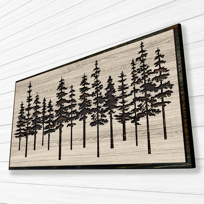 Pine tree forest wood wall art carved into solid wood. The stunning artwork features a carved pine tree scene nestled against a serene forest backdrop. That natural variations in the wood grain add a depth and character to the overall design, creating a warm and inviting atmosphere for any room.