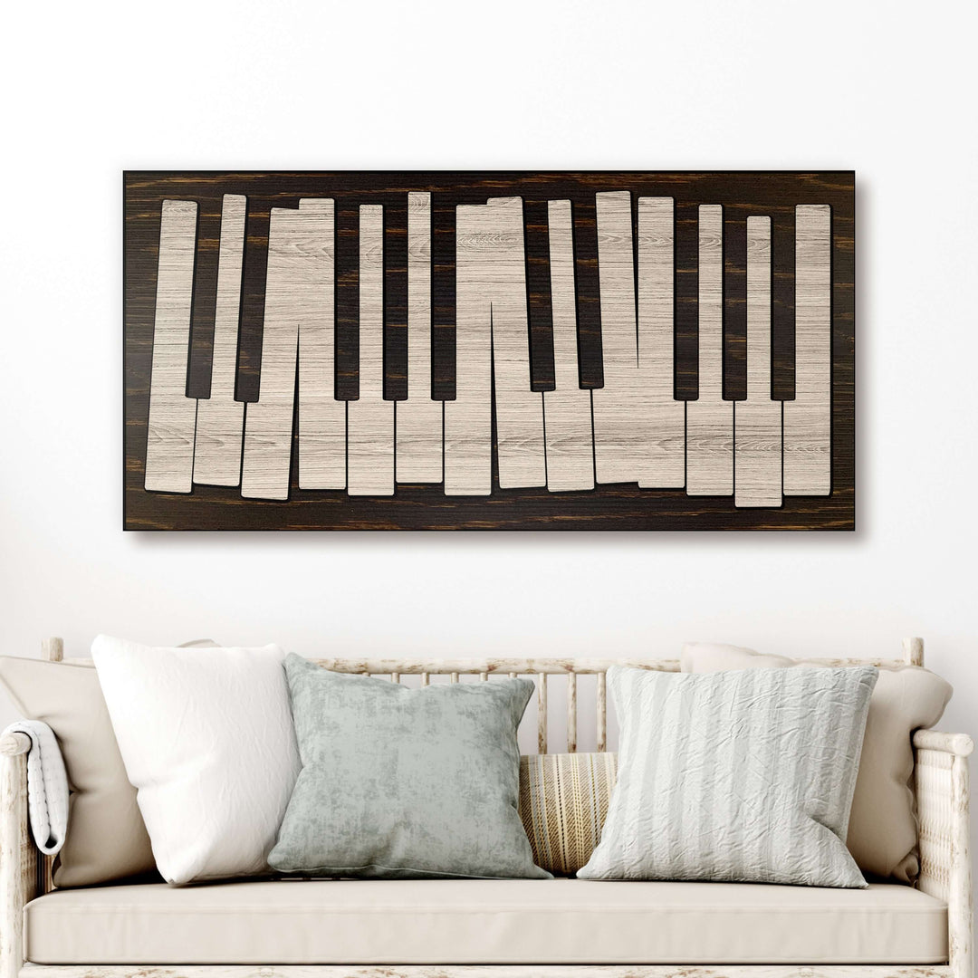 Wooden piano key design wall art above a sofa with decorative pillows.