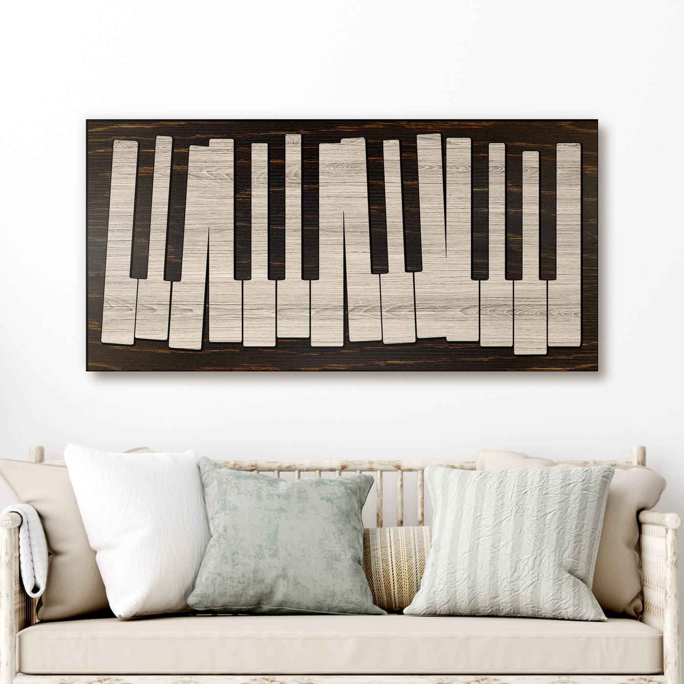 Wooden piano key design wall art above a sofa with decorative pillows.