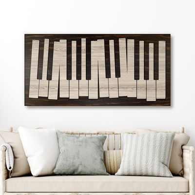 Wooden piano key design wall art above a sofa with decorative pillows.