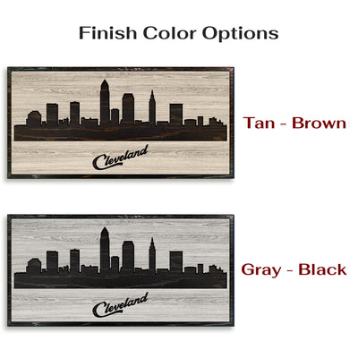 Carved wood wall art featuring the Cleveland, Ohio city skyline with detailed buildings and natural wood grain finish.